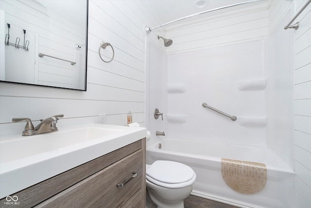 full bathroom with toilet, shower / tub combination, wood-type flooring, vanity, and wood walls