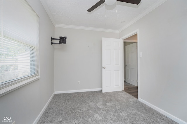 interior space with crown molding, a textured ceiling, and ceiling fan