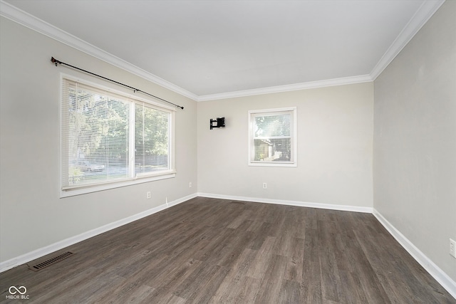 spare room with ornamental molding and dark hardwood / wood-style floors