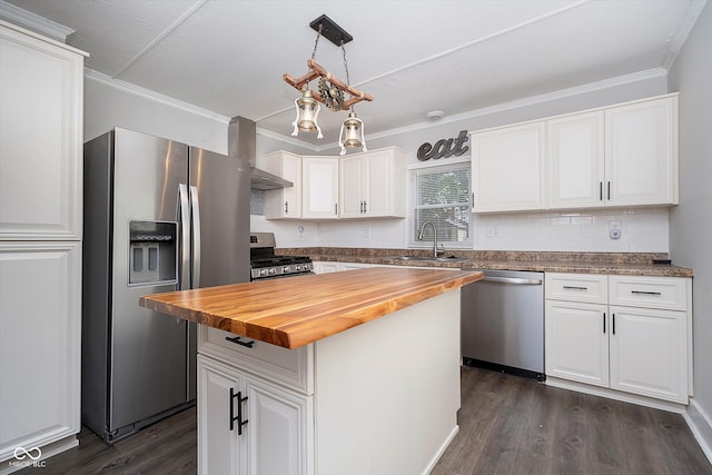 kitchen featuring white cabinetry, wood counters, stainless steel appliances, sink, and a center island