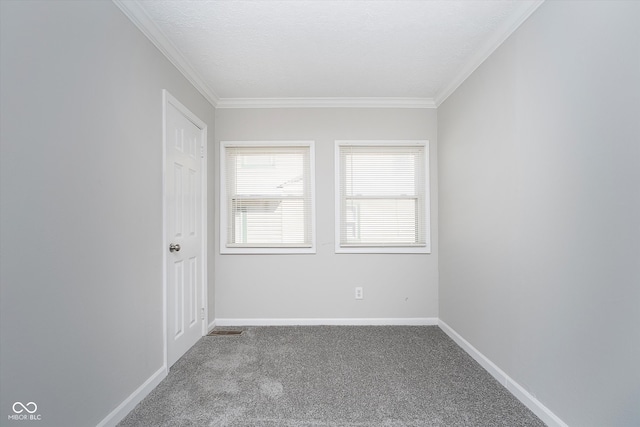 spare room with crown molding, carpet, and a textured ceiling