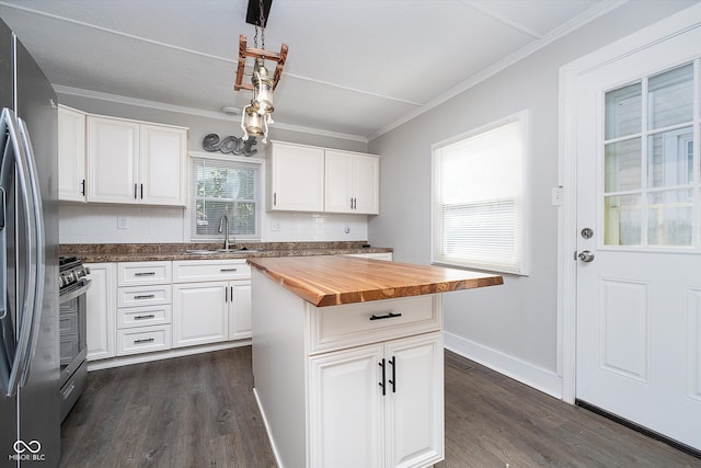 kitchen with white cabinetry, a center island, and plenty of natural light