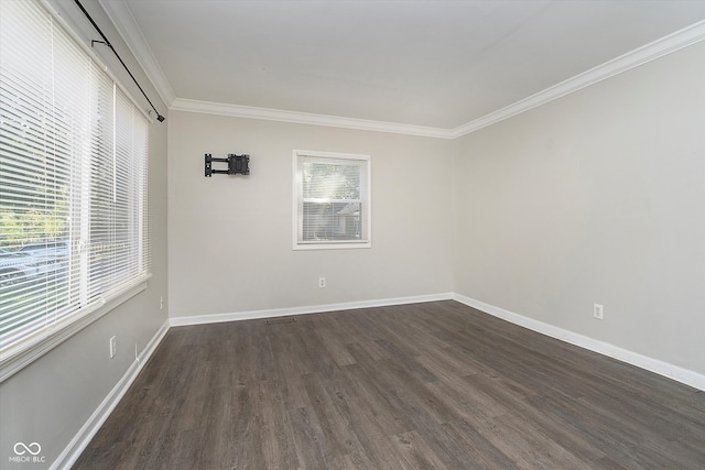 spare room featuring crown molding and dark hardwood / wood-style flooring