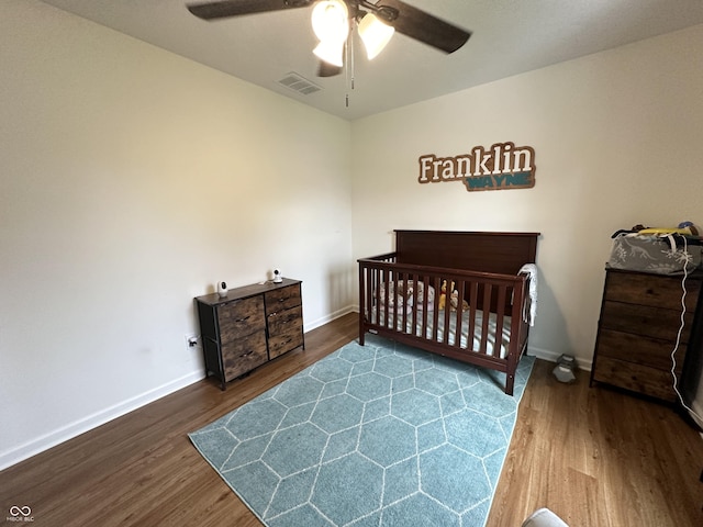 bedroom with visible vents, baseboards, ceiling fan, and wood finished floors