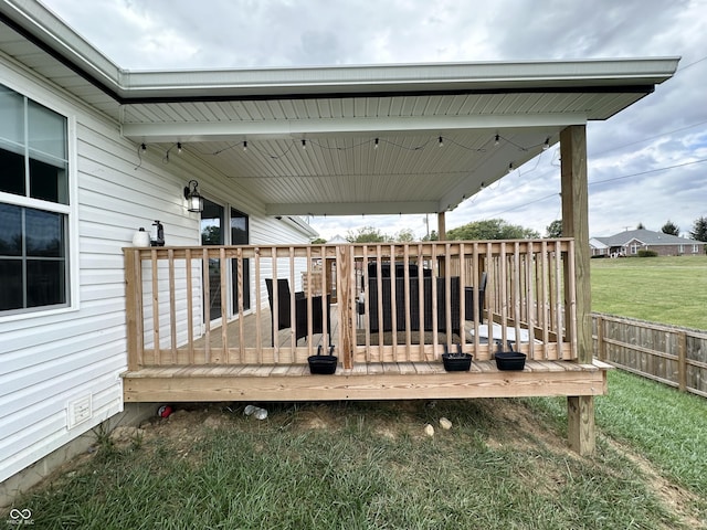 wooden deck featuring a lawn