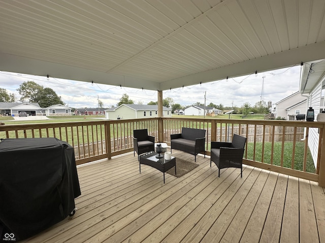 wooden deck featuring a yard, a residential view, an outdoor hangout area, and a grill