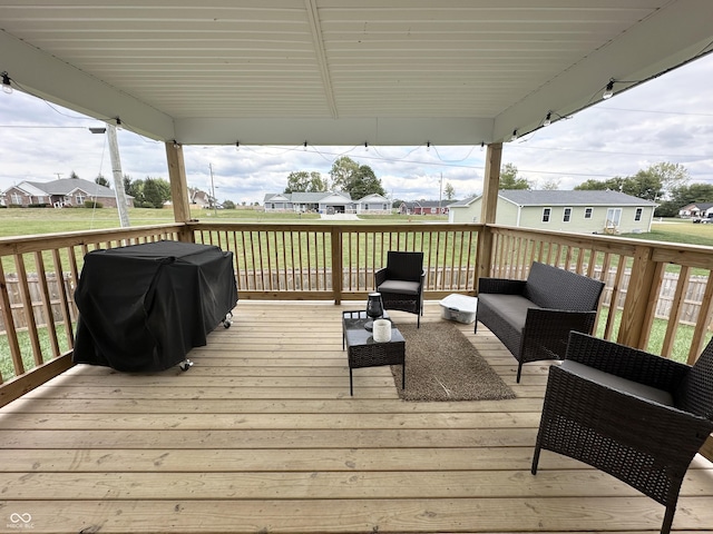 deck featuring a residential view, an outdoor living space, and grilling area