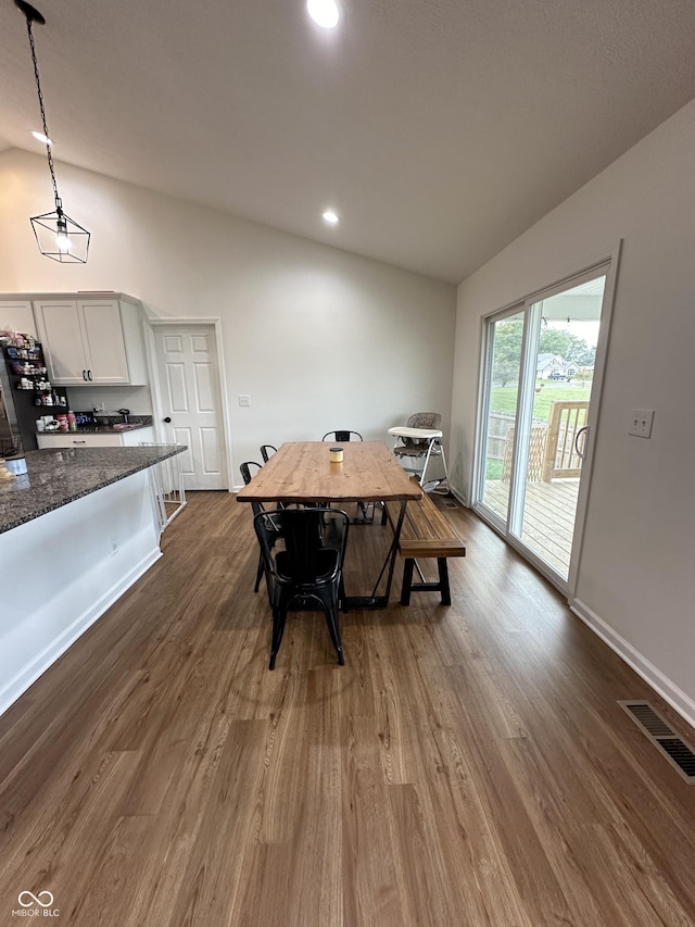 dining area with dark wood-style flooring, visible vents, recessed lighting, and lofted ceiling