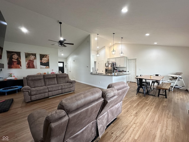 living room featuring recessed lighting, high vaulted ceiling, ceiling fan, and light wood-type flooring