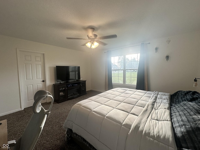 bedroom featuring ceiling fan, dark colored carpet, and a textured ceiling