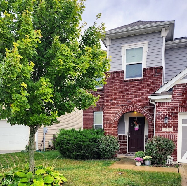 view of front of house with a front yard and a garage