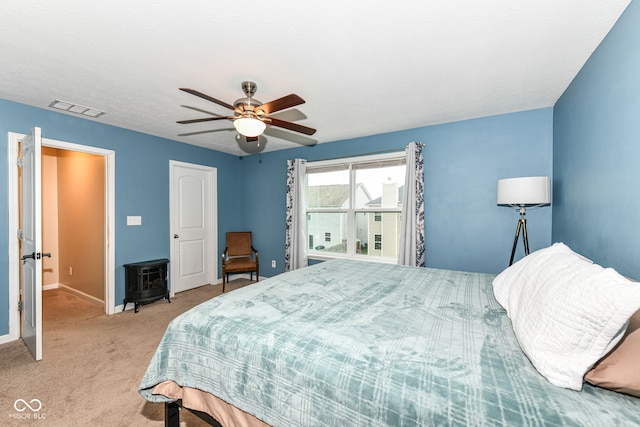 bedroom featuring light colored carpet and ceiling fan