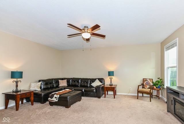 carpeted living room featuring a textured ceiling and ceiling fan