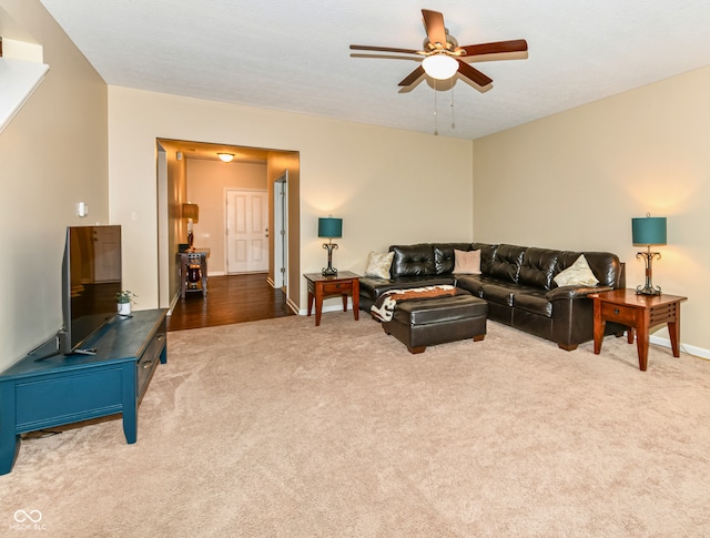 carpeted living room featuring ceiling fan