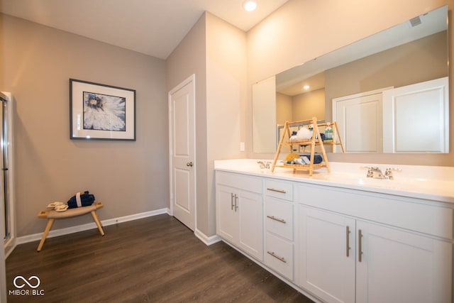 bathroom with vanity and hardwood / wood-style flooring