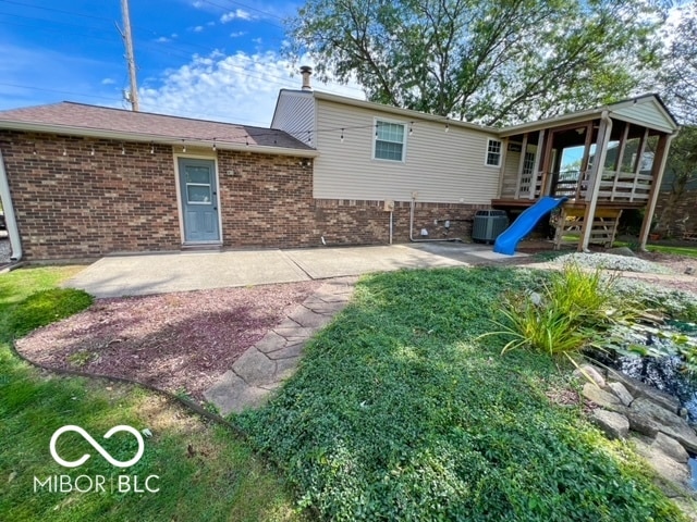 back of property with a patio and cooling unit