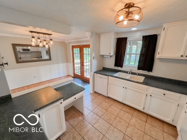 kitchen featuring dishwasher, sink, french doors, hanging light fixtures, and white cabinets