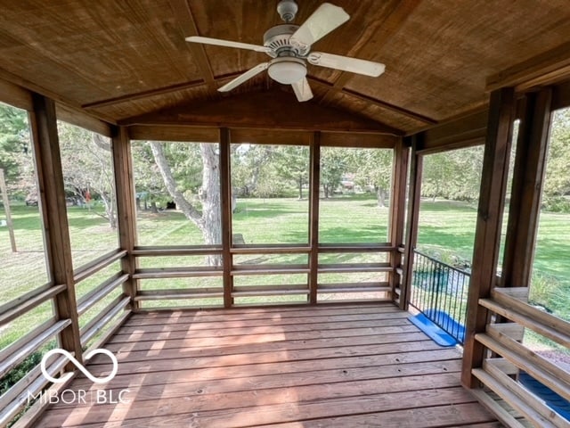 unfurnished sunroom featuring wood ceiling, vaulted ceiling, and ceiling fan