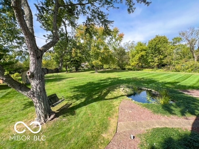 view of community featuring a water view and a lawn