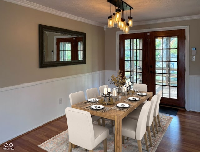 dining space with ornamental molding, french doors, dark wood-type flooring, and a textured ceiling