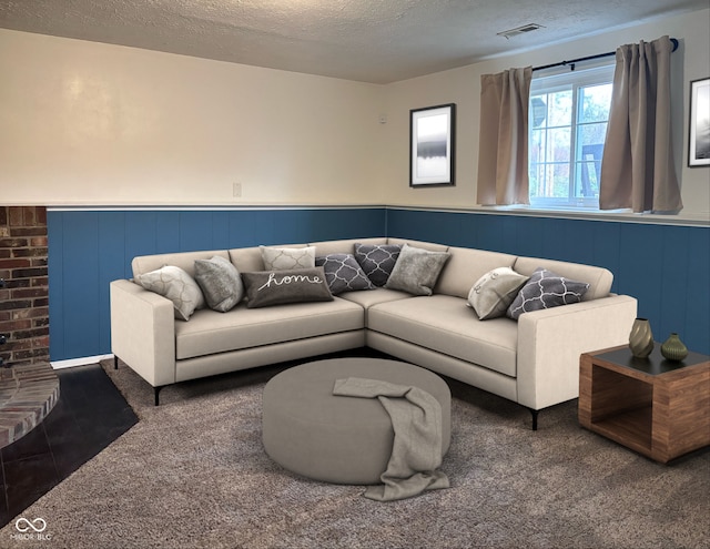 living room featuring a textured ceiling and carpet