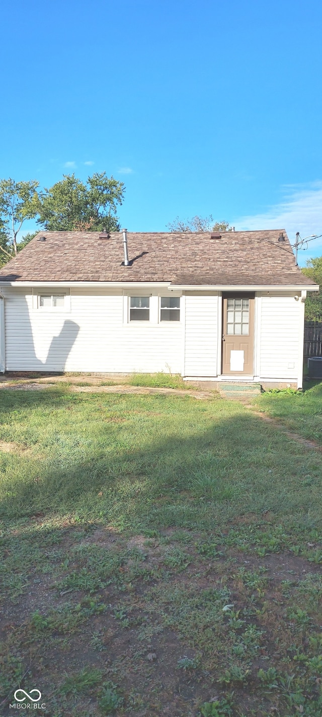 rear view of house with a yard