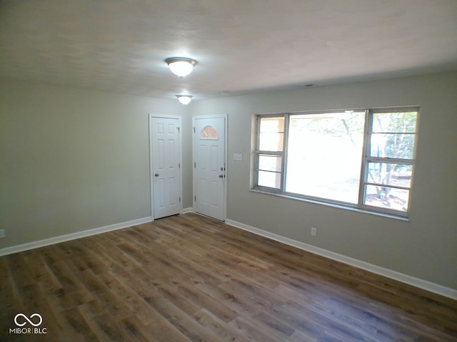 interior space with plenty of natural light and dark hardwood / wood-style flooring