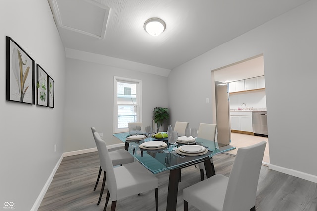 dining area with sink and dark wood-type flooring