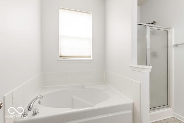 bathroom featuring separate shower and tub