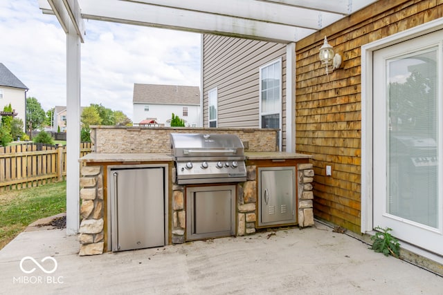 view of patio featuring a grill and exterior kitchen