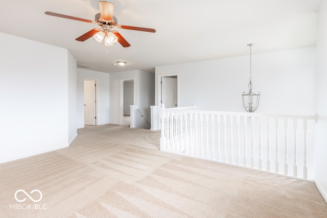 unfurnished room featuring light carpet and ceiling fan