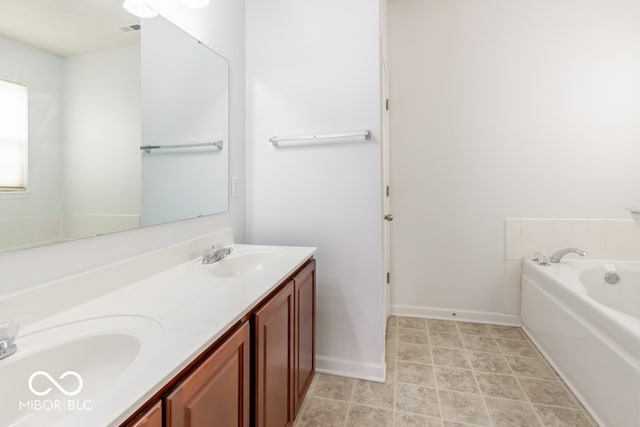 bathroom with vanity and a tub