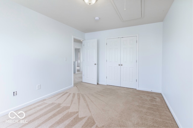 unfurnished bedroom with light carpet and a closet