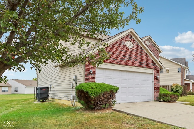 view of front of property featuring a garage, a front lawn, and central AC unit