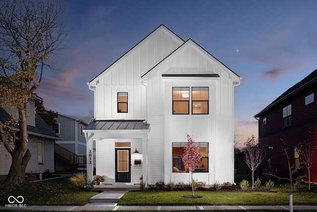 modern inspired farmhouse featuring a lawn