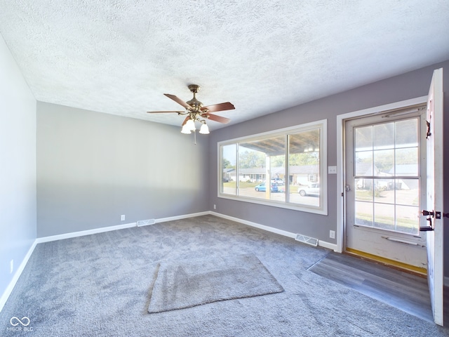 spare room with ceiling fan, a textured ceiling, and hardwood / wood-style floors