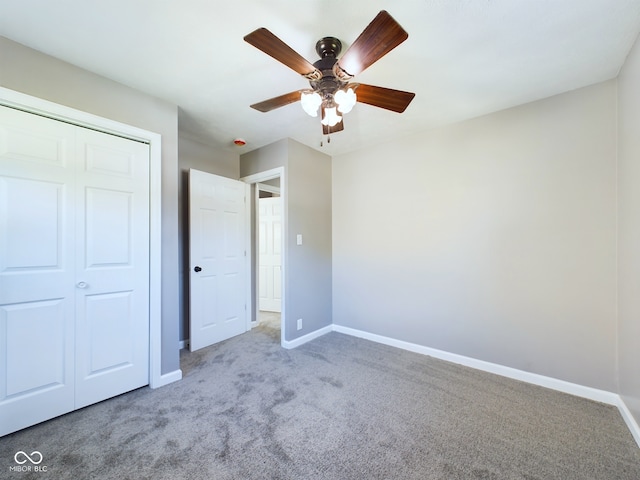 unfurnished bedroom with carpet flooring, ceiling fan, and a closet