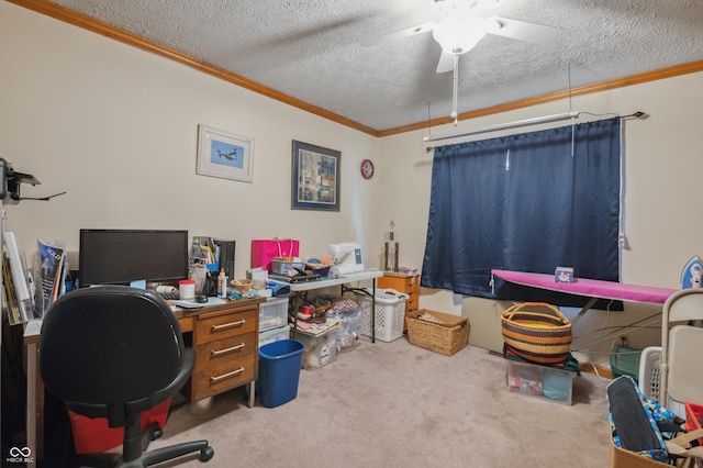 carpeted home office with a textured ceiling, crown molding, and ceiling fan