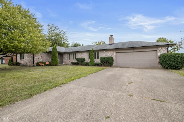 ranch-style home featuring a chimney, driveway, a front yard, a garage, and brick siding