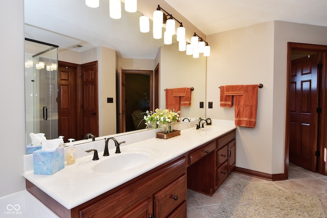 bathroom with walk in shower, vanity, and tile patterned floors