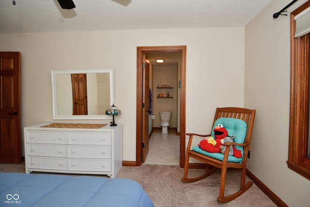 bedroom with connected bathroom, ceiling fan, and light colored carpet