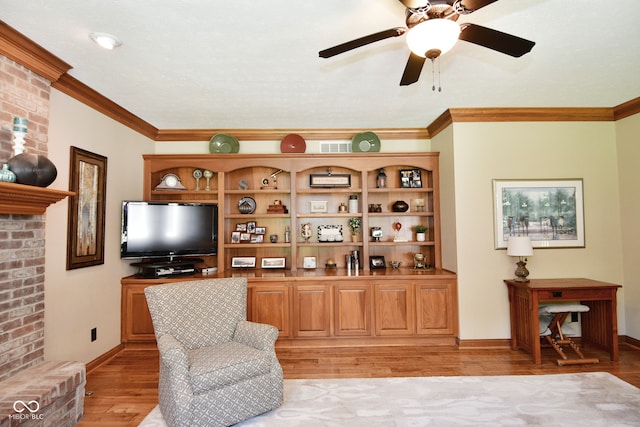 sitting room featuring ceiling fan, light hardwood / wood-style flooring, and crown molding