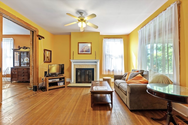 living room featuring ceiling fan and hardwood / wood-style floors