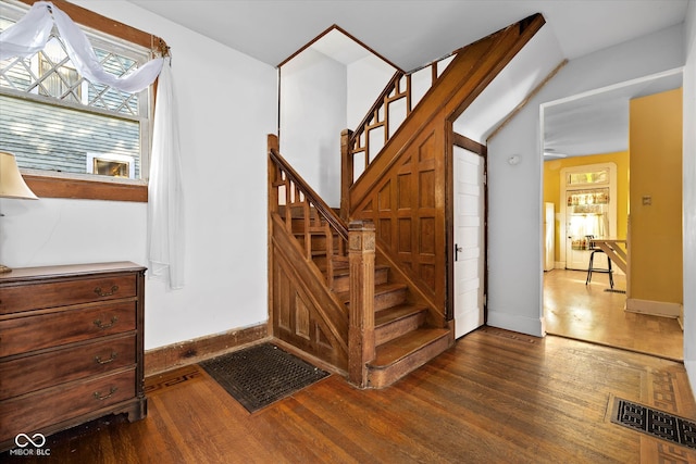 stairs featuring hardwood / wood-style floors