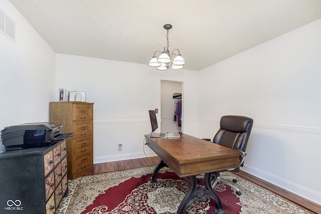 office space featuring hardwood / wood-style floors and a notable chandelier