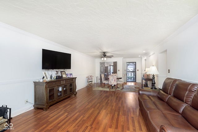 living room with a textured ceiling, wood-type flooring, crown molding, and ceiling fan