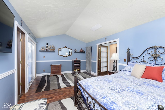 bedroom featuring lofted ceiling and dark wood-type flooring