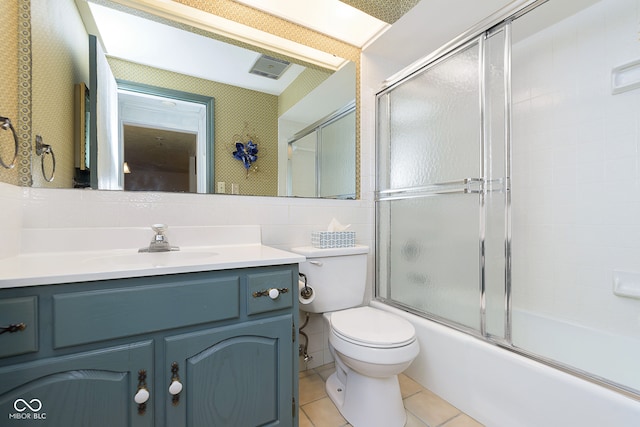 full bathroom with enclosed tub / shower combo, tile patterned floors, vanity, and toilet