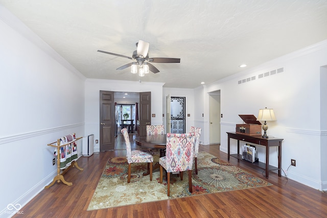 dining space featuring crown molding, dark hardwood / wood-style floors, and ceiling fan