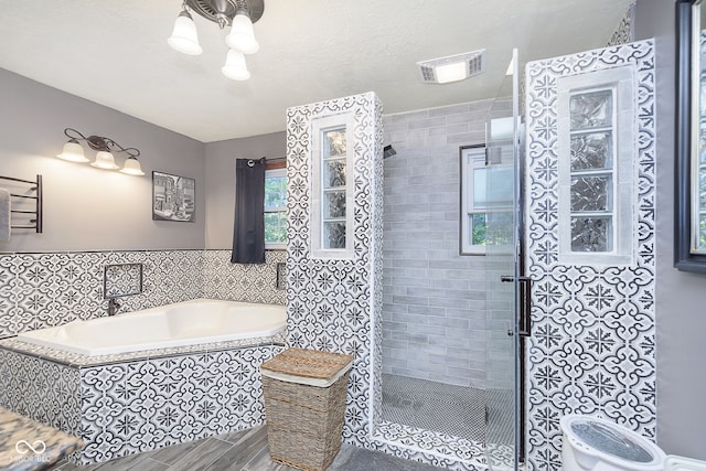 bathroom with plus walk in shower and tile walls